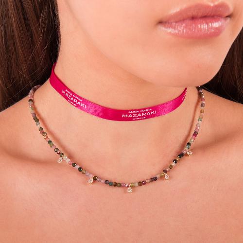 Cord necklace with tourmaline and white solitaires.
